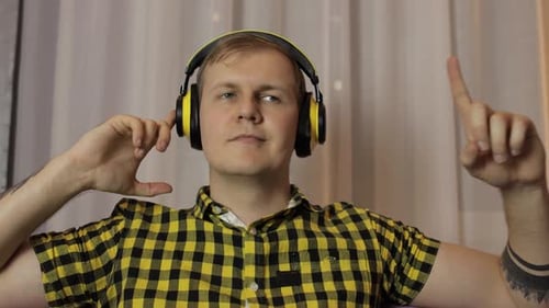 Man Listening to Music on Yellow Headphones