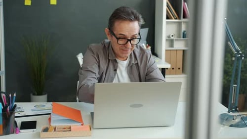Emotional Mature Man Working with Laptop in Office Expressing Negative Emotions and Leaving