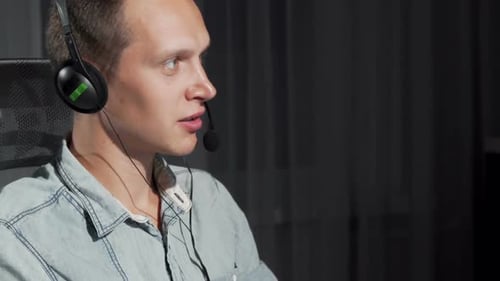 Cropped Shot of a Handsome Young Man Working at Call Center on Night Shift