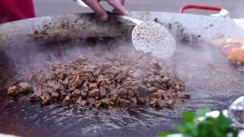 Pieces of Meat Are Roasted in Oil Lose-up in the Fresh Air.