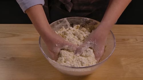 Close-up Mixing Dough in a Bowl with Hands