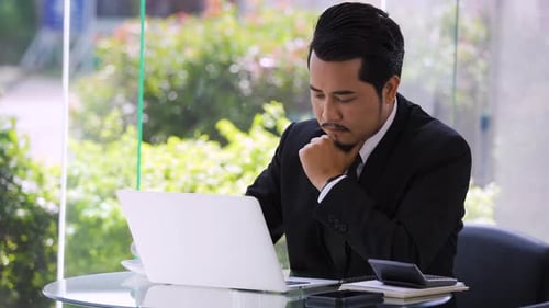 young stressed business man using laptop and working problem