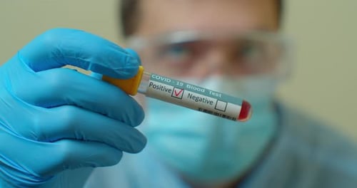 Doctor Showing Tube, Negative Result of Blood Test for Coronavirus, Covid-19.