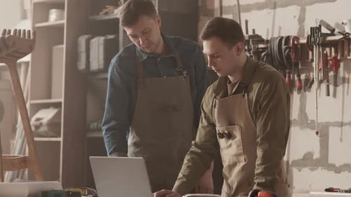 Carpenters Working on Laptop in Woodworking Workshop