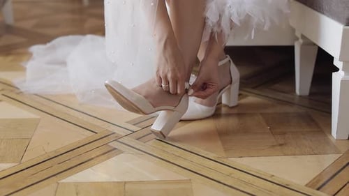 Woman Fastening White High Heel Strap