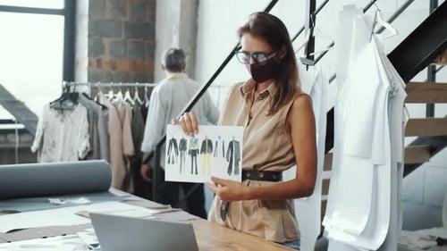Woman Presents Fashion Designs in Workplace
