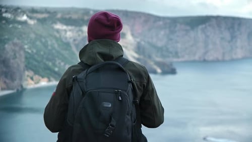 Back View Male Backpacker Enjoying Success Contemplating Sea Scenery From Mountain Top