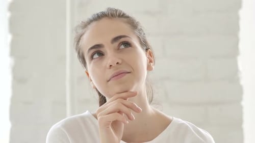 Young Woman Thinking with Hand to Face
