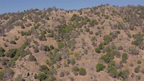 Aerial Drone Shot Ascending Over the Top of a Mountain to Reveal Vast Rolling Hills in California
