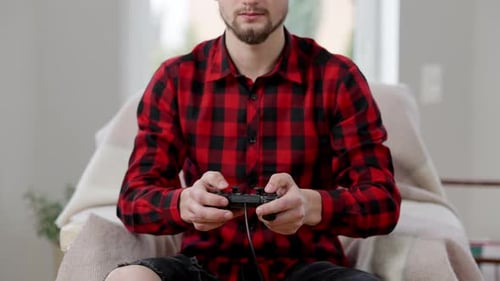 Man Playing Video Games Indoors at Home