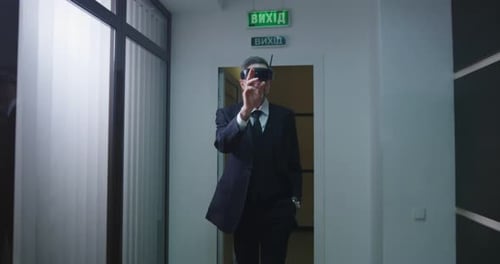 Businessman Using VR Glasses in Office Corridor