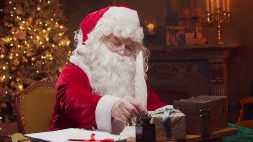 Santa Writing Letter at Christmas Table