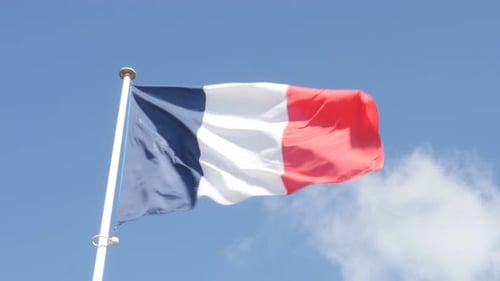 French Flag Waving Proudly Against Blue Sky