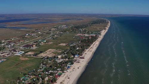 Beautiful flight in summer over the beach. People are resting near the sea.