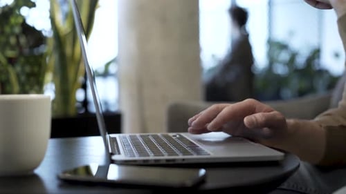 Hands Typing on Laptop Computer Keyboard Close Up