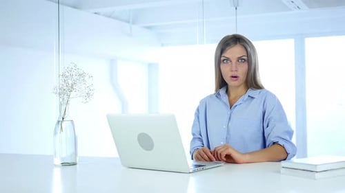 Young Woman Reacts With Surprise To Laptop