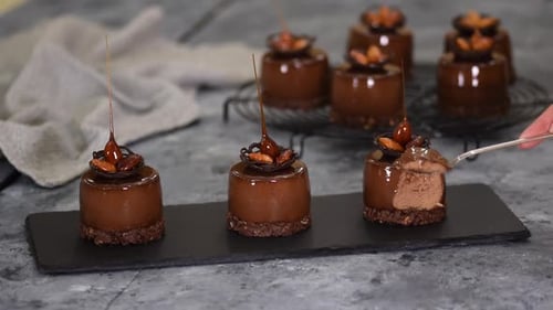 Chocolate Dessert with Almonds Being Cut Open