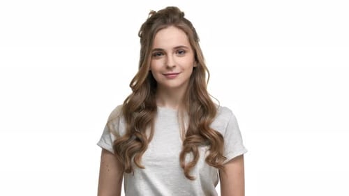 Smiling Young Woman with Wavy Hair on White Background