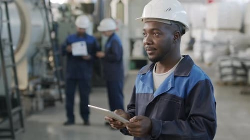 African-American Factory Worker Using Tablet