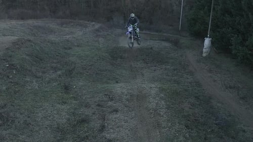 Motorcycle Rider Jumps on Rural Dirt Track
