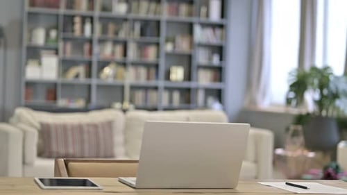Young Woman Coming and Sitting in Loft Office