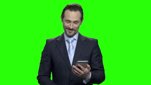 Businessman in Suit Using Smartphone on Green Screen
