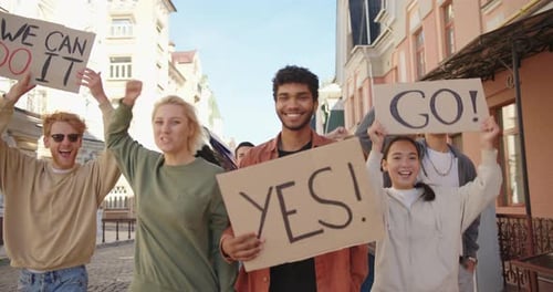 Group of Young People Marching with Protest Signs