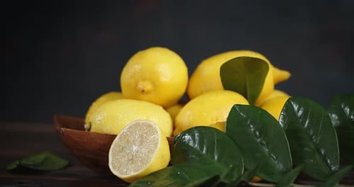 Lemons in Bowl with Green Leaves