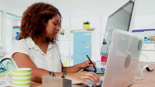 Woman Working on Computer and Graphic Tablet