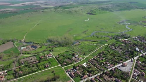 A thoughtfully planned out Bulgarian town bordering the countryside. The aerial view spins to revea