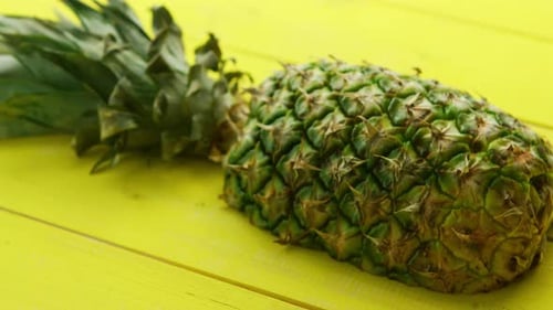 Fresh Pineapple on a Sunny Yellow Surface