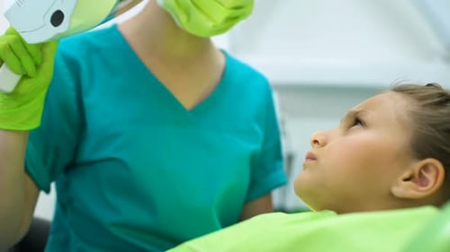 Child Receives Dental Treatment in Bright Office