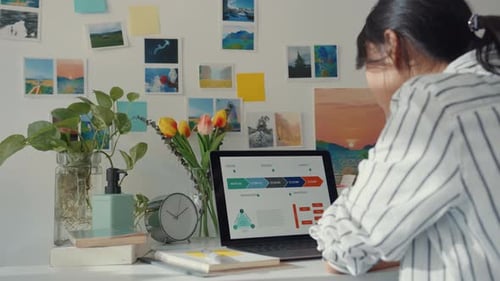 Woman Reviews Project Data at Home Office Desk