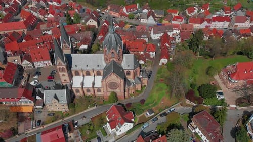 Beautiful flight over the catholic cathedral, houses, city.