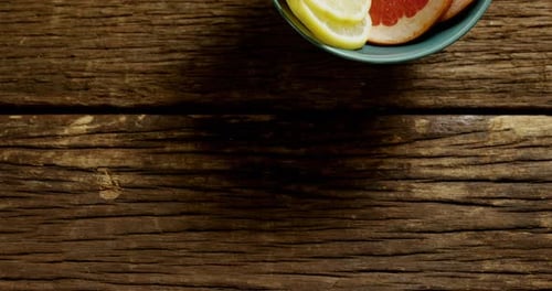 Citrus Fruit Displayed in Bowl on Wooden Table
