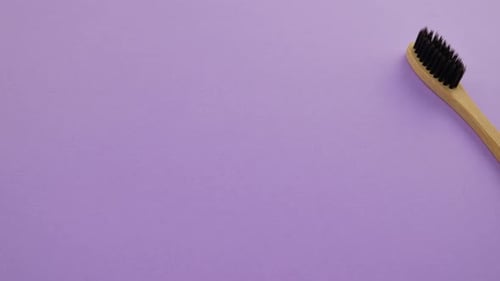 Wooden Bamboo Toothbrushes on a Purple Surface