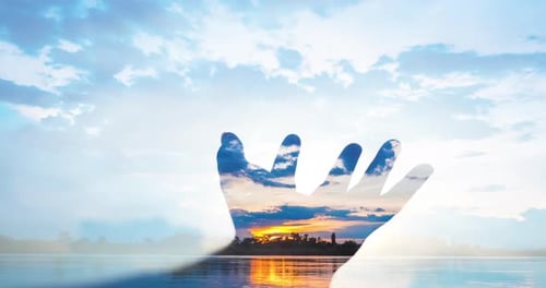 Double exposure with human hand and sky timelapse