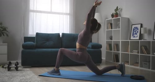 Woman Doing Lunge Stretch at Home in Living Room