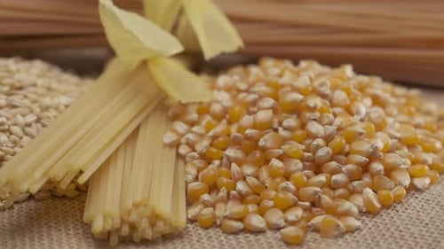 Uncooked Grains and Pasta Displayed on Burlap