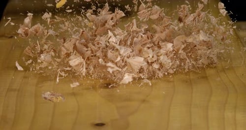 Wood Chips Falling on a Board, Slow Motion 4K