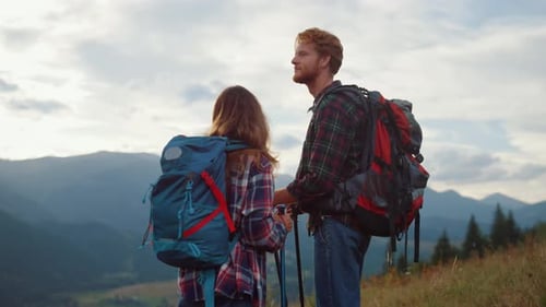 Couple Hiking in the Mountains Enjoying the View