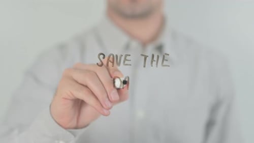 Hand Writes "Save the Date" Message on Glass