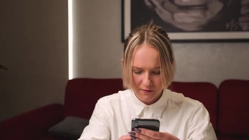 Woman Using Smartphone Device Indoors