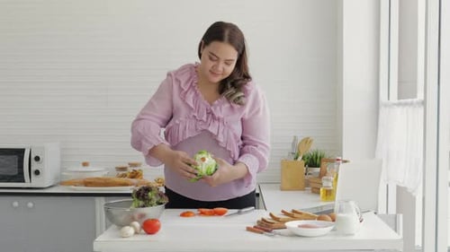Woman Prepares Salad in Bright Kitchen