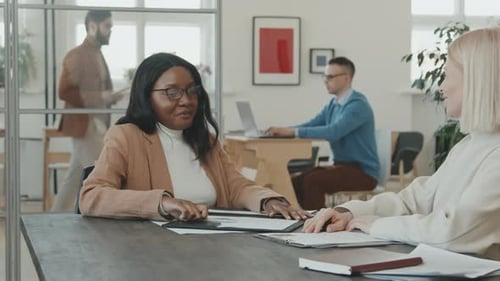 Businesswomen Conclude Agreement With a Handshake in Office