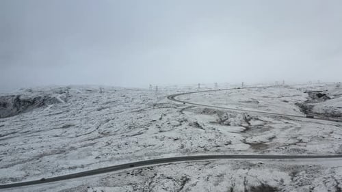 Drone Over Winding Road In Snowy Landscape