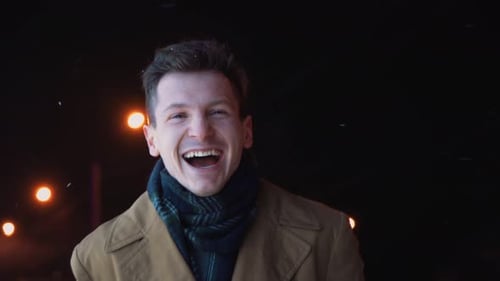 Laughing Man in Coat Outside at Night