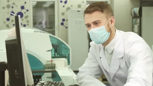 Scientist Working on Computer in Modern Laboratory