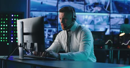 Male Operator Using Computer in Surveillance Center