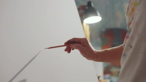 Artist Drawing on Canvas in Art Studio